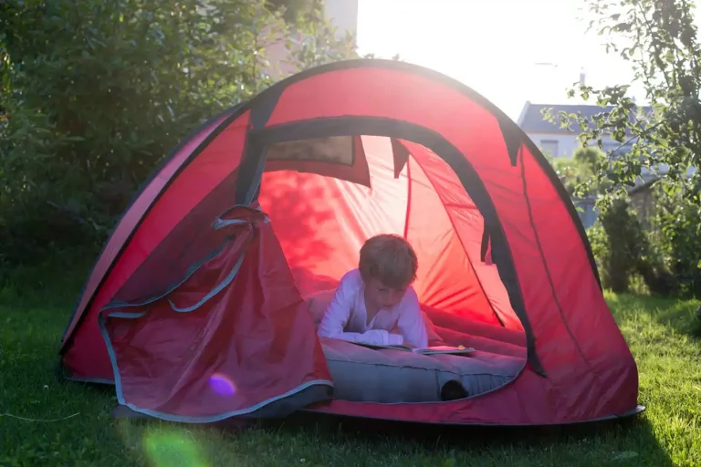 Boy Camping with a tent using Air Mattress