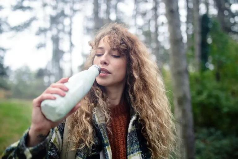 Women Drinking Water at Campsite