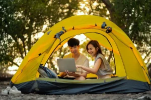 Couple using wifi net while camping