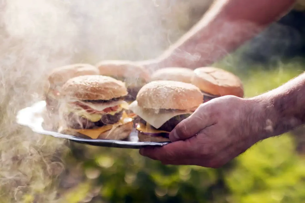 cheeseburgers amidst smoke at backyard